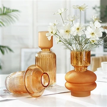 arranging flowers in a glass vase to create an elegant display